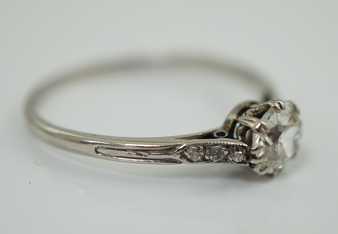 A platinum? and single stone diamond set ring, with six stone diamond chip set shoulders